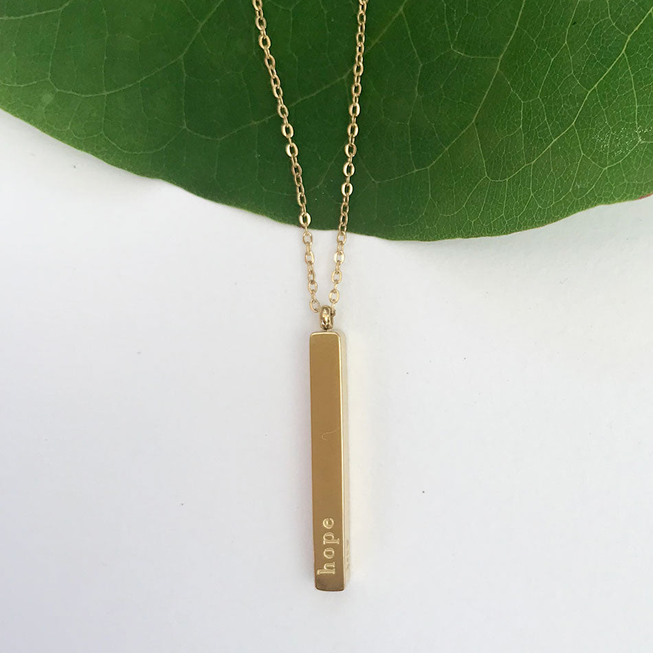 Fair trade gold hope necklace handmade by survivors of human trafficking