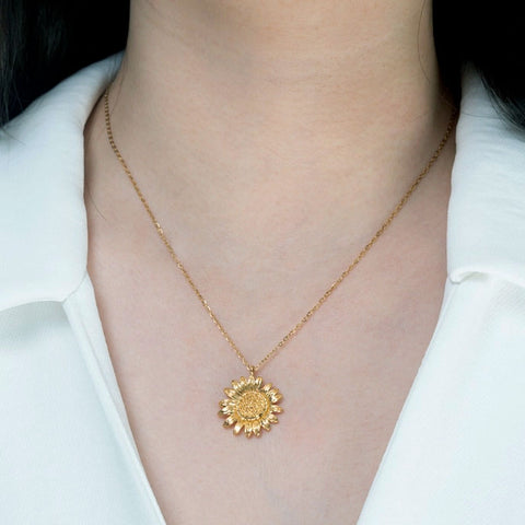 Sunflower necklace handmade by survivors of human trafficking