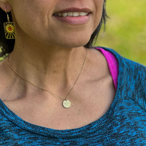Fair trade gold bee necklace handmade by survivors of human trafficking
