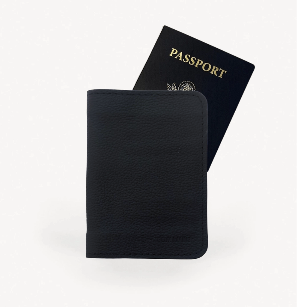 Black leather passport holder with passport shown.