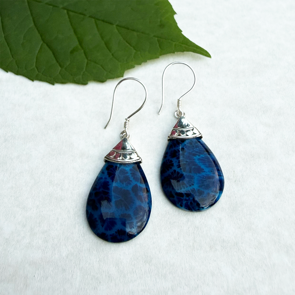 Sterling silver accent earrings with blue coral teardrop design.