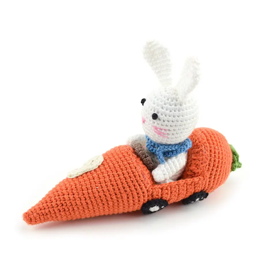 Crocheted cotton white bunny in carrot car.