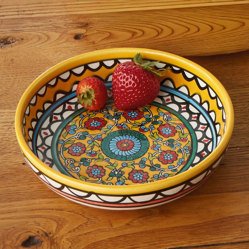 Round yellow ceramic bowl with hand-painted floral design.