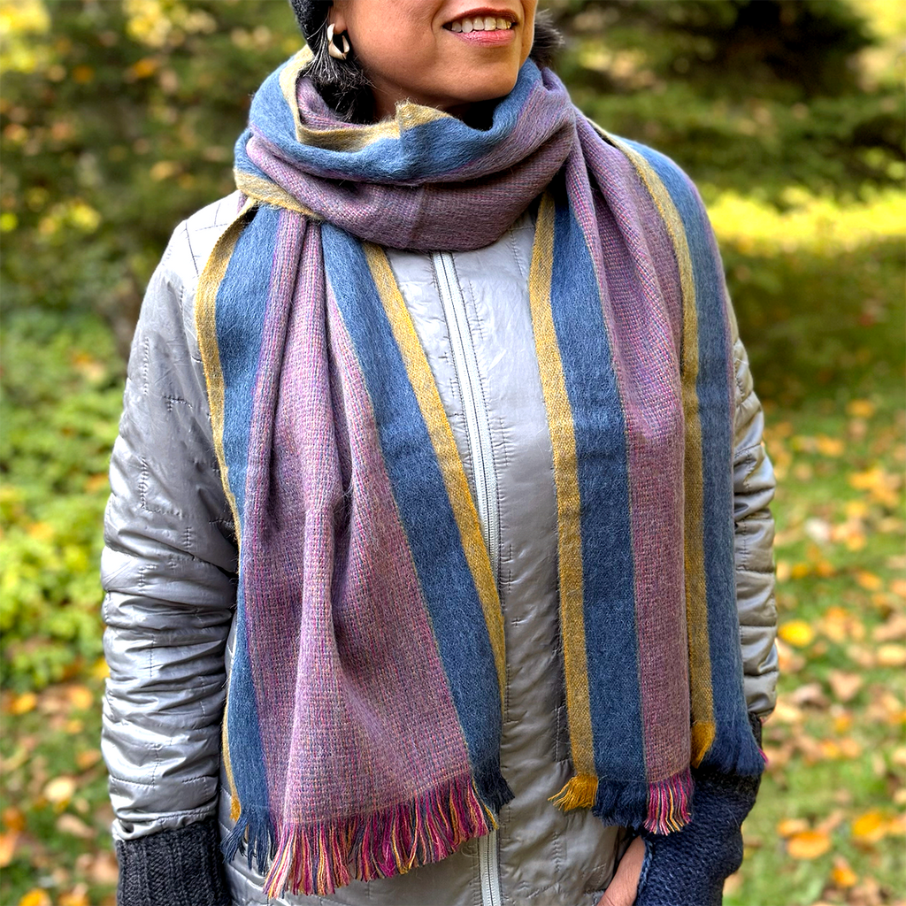 Mauve, blue and yellow alpaca scarf on model 