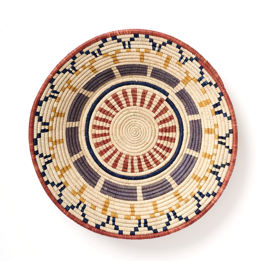 Large round basket natural background with African design in tan, black and gray