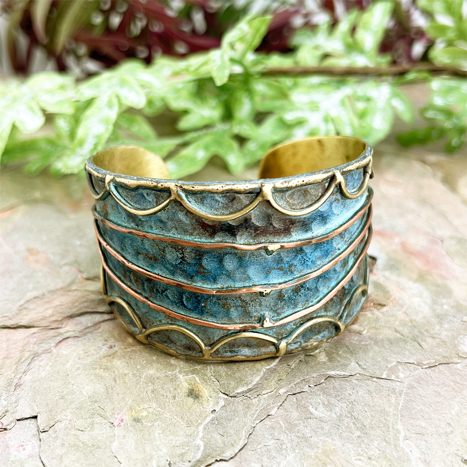 Blue brass patina wide cuff with gold and copper line design.