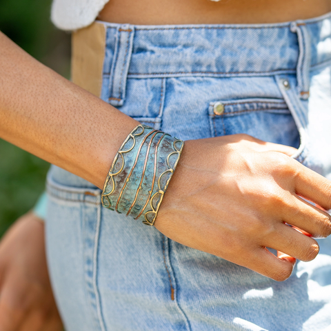 Blue brass patina wide cuff with gold and copper line design.