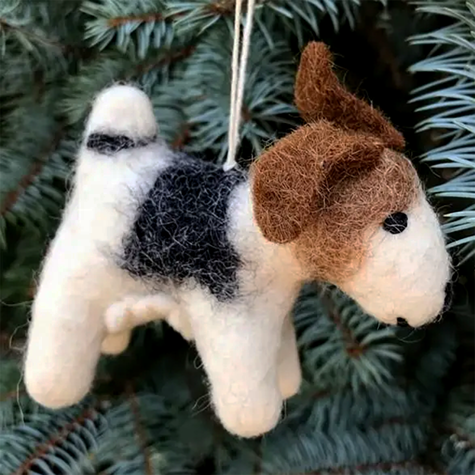 Felted white, brown and black dog ornament on pine tree