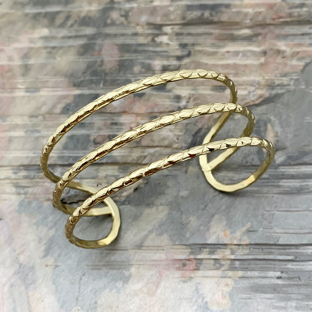 Gold cuff bracelet with 3 strands of metal