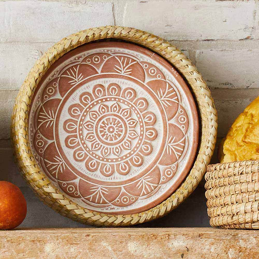 Basket with ceramic bread warmer inside with mandala design.