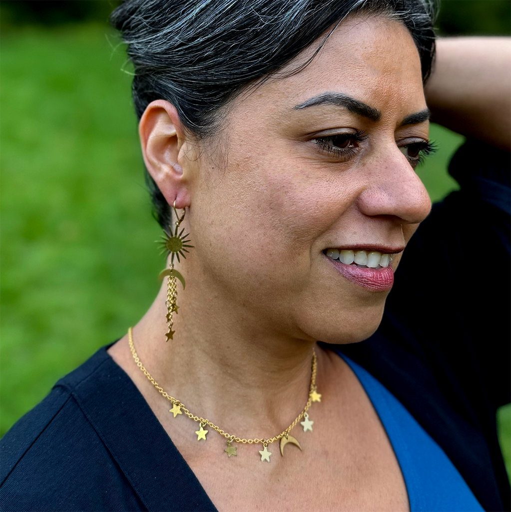 Brass chain necklace with moon and stars charms on model