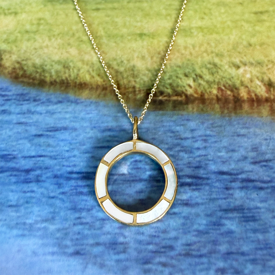 Necklace circle of brass with inlaid mother-of-pearl on gold chain.