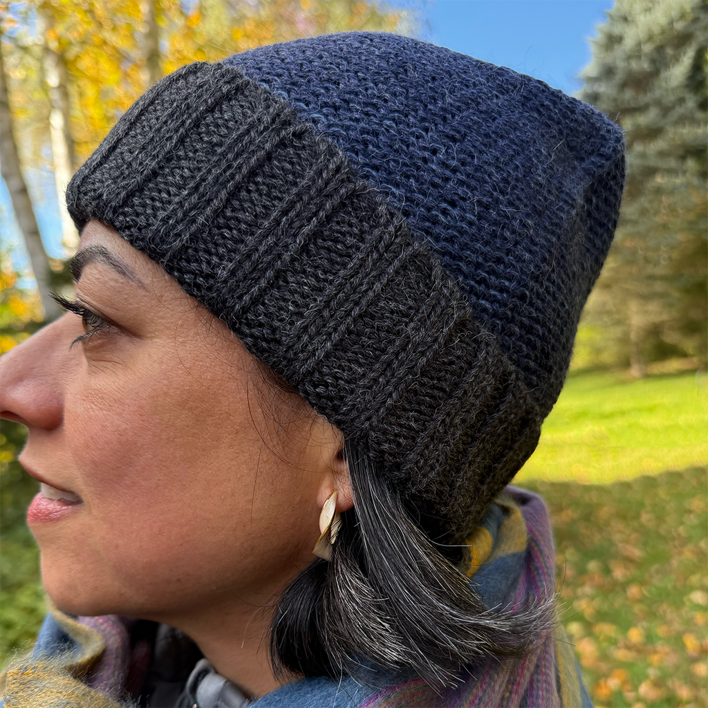 Baby alpaca hat navy with charcoal cuff on model