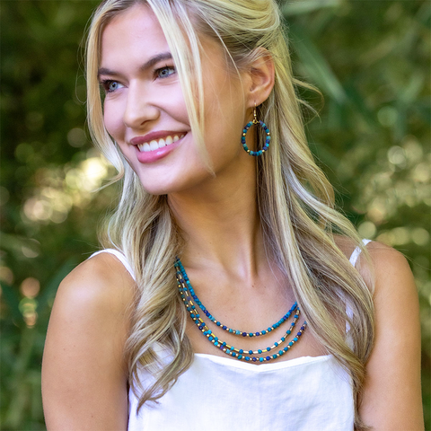 Three strand necklace blue sari fabric beads and gold beads.