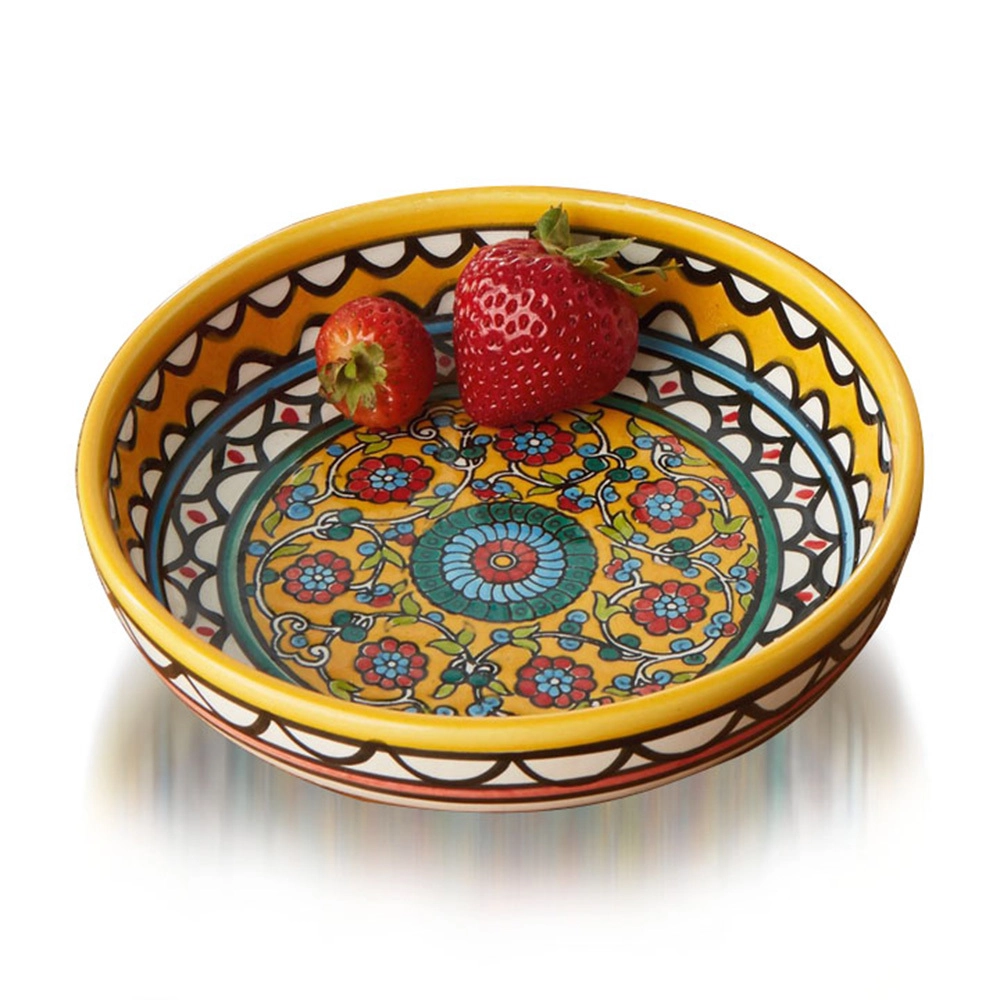 Round yellow ceramic bowl with hand-painted floral design.