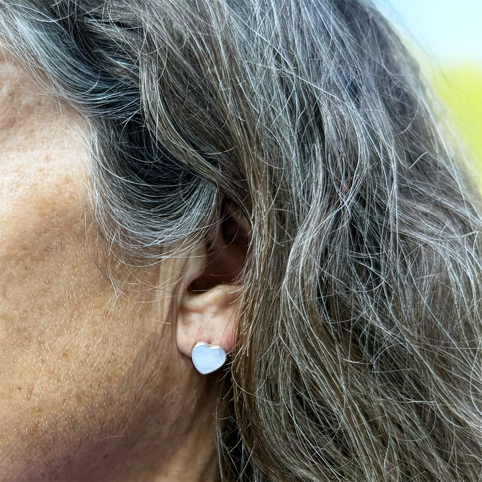 Mother-of-pearl heart studs in sterling silver casing