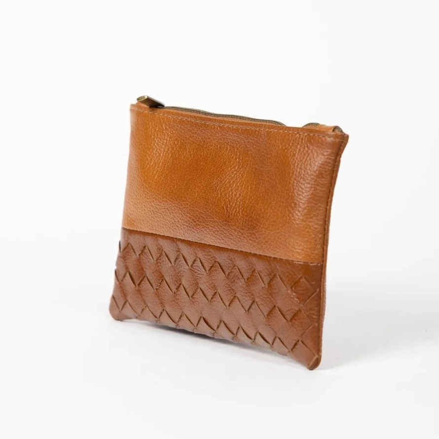 Light brown leather pouch with woven design on front.