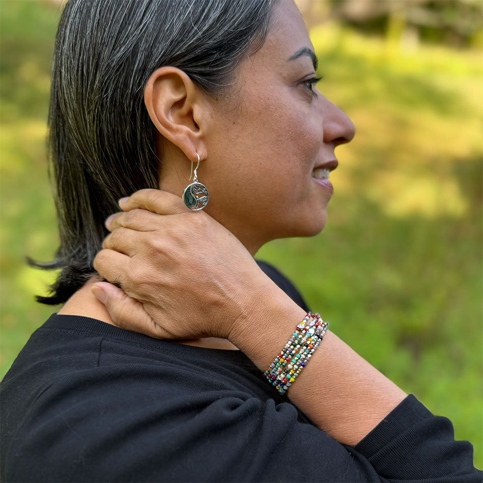 Fair trade bracelet with colorful rainbow beads and silver beads.  