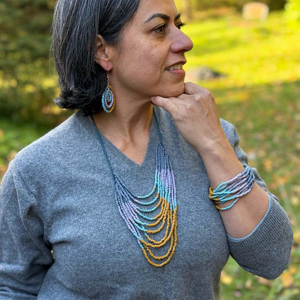 Glass jewelry set with multi-strand necklace, earrings and bracelet in gold, purple and blue colors.