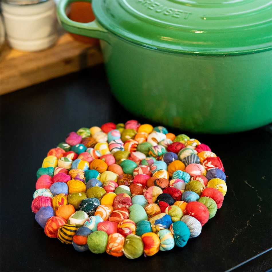 Round trivet made out of balls of recycled sari fabric