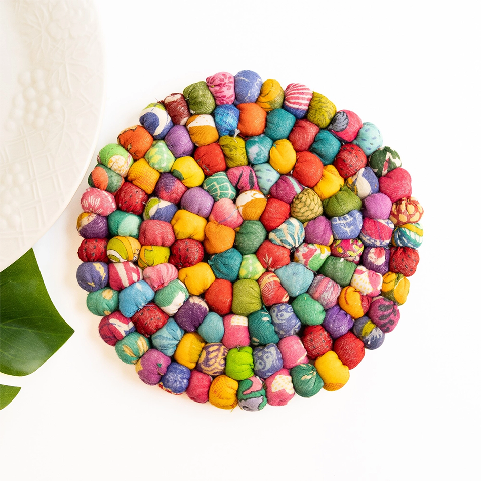 Round trivet made out of balls of recycled sari fabric