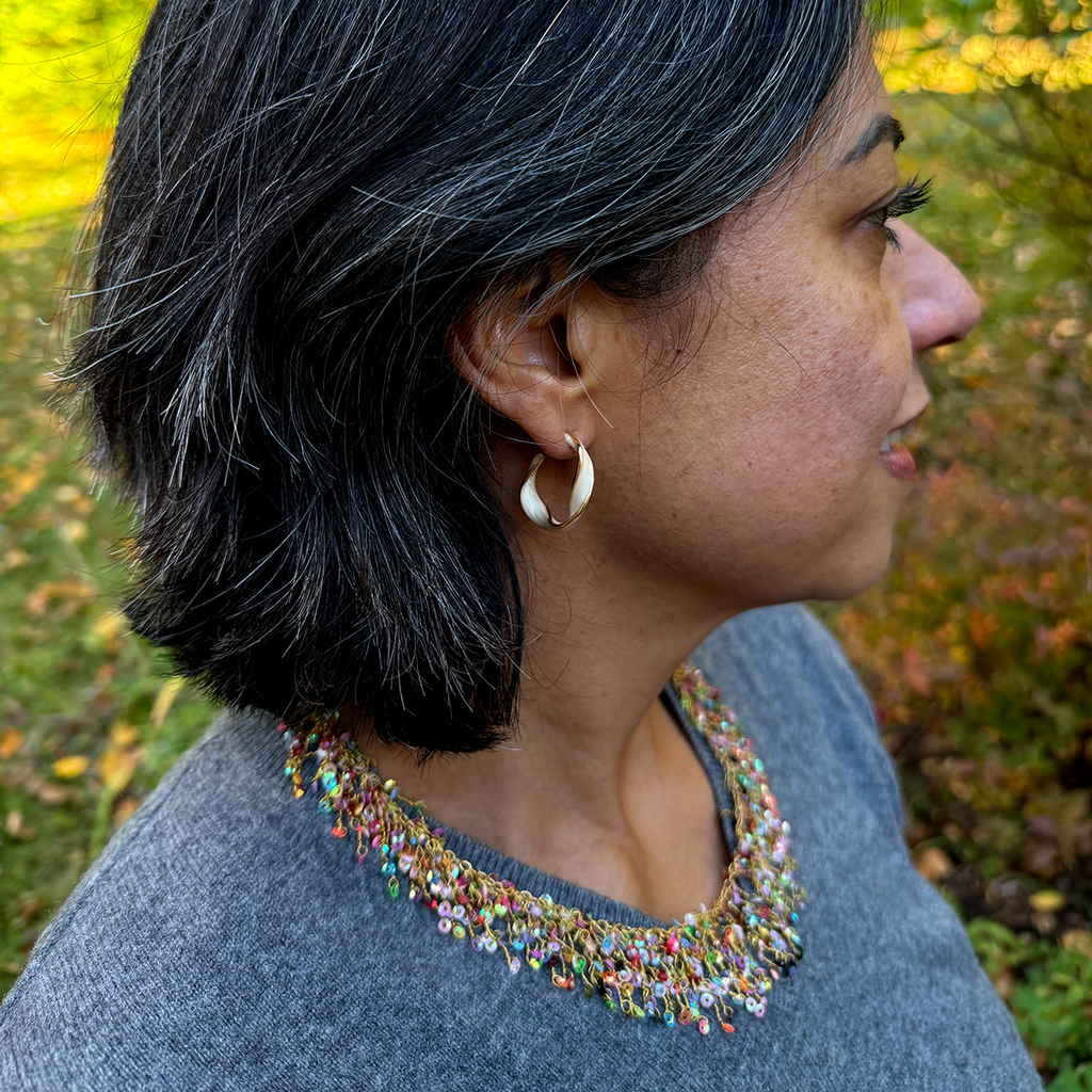 Multi-colored necklace with several strands of sequins on model