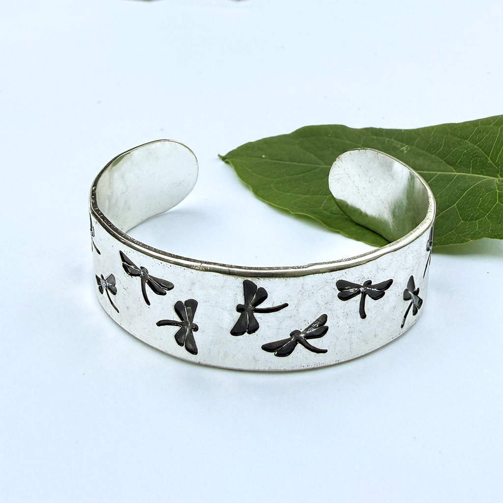 Silver plated cuff bracelet with engraved black dragonflies