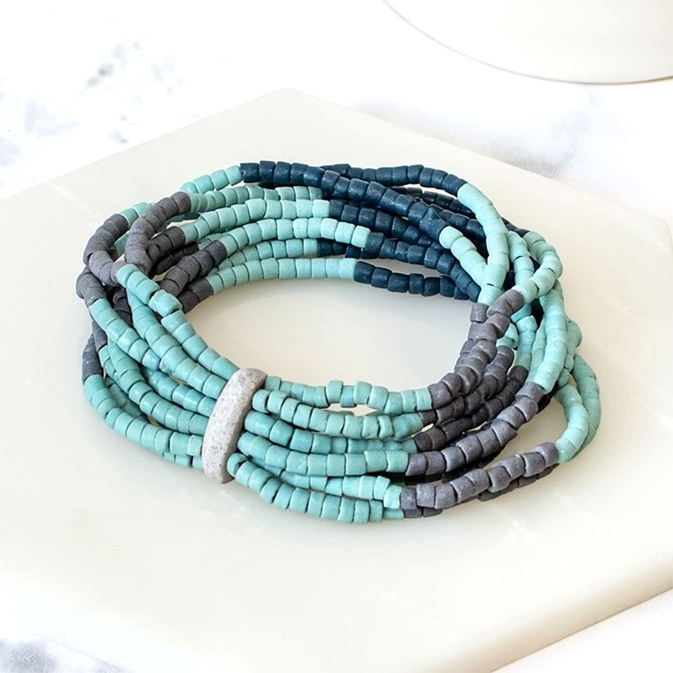 Glass bead bracelet with several strands of turquoise, navy and gray beads