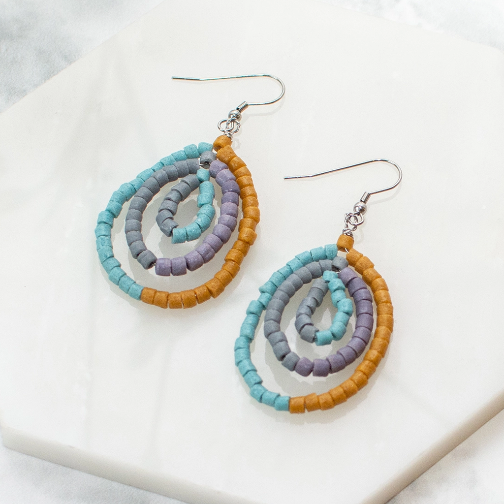 Teardrop shaped earrings with three strand of glass beads in gold, blue and purple