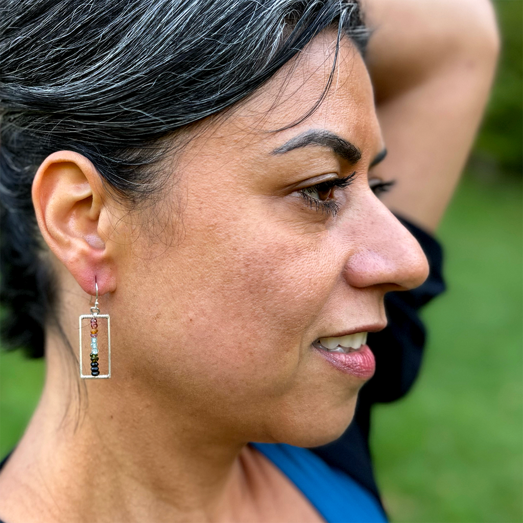 Model with silver rectangle earrings with tiny multi-colored tourmaline stones in the middle