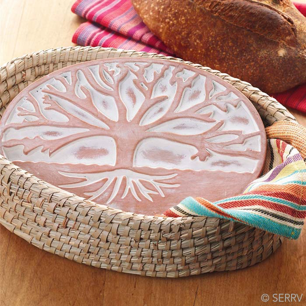 Basket with ceramic bread warmer inside with tree design.