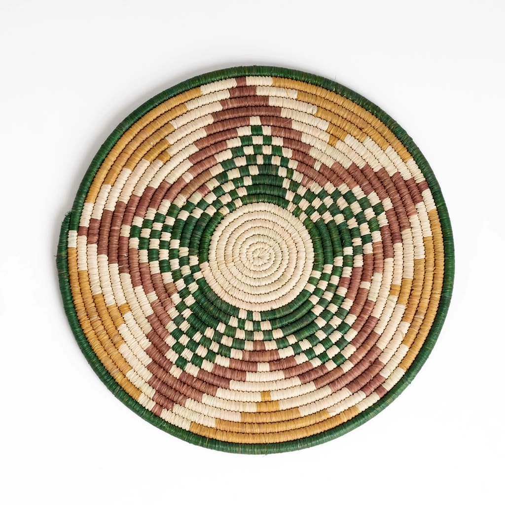 Round hand woven trivet with star design in green, gold, tan and brown