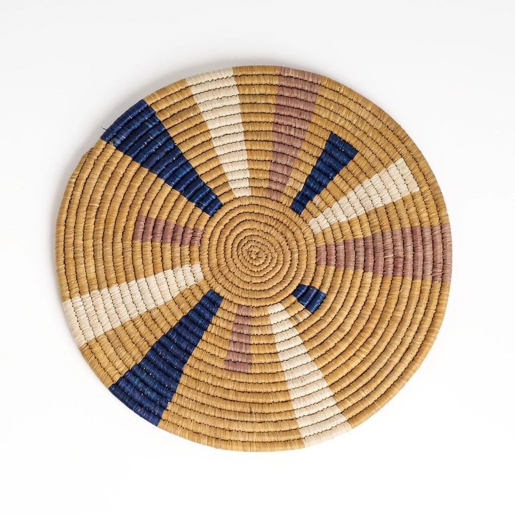 Round trivet banana fiber tan with splashes of pink, white and blue