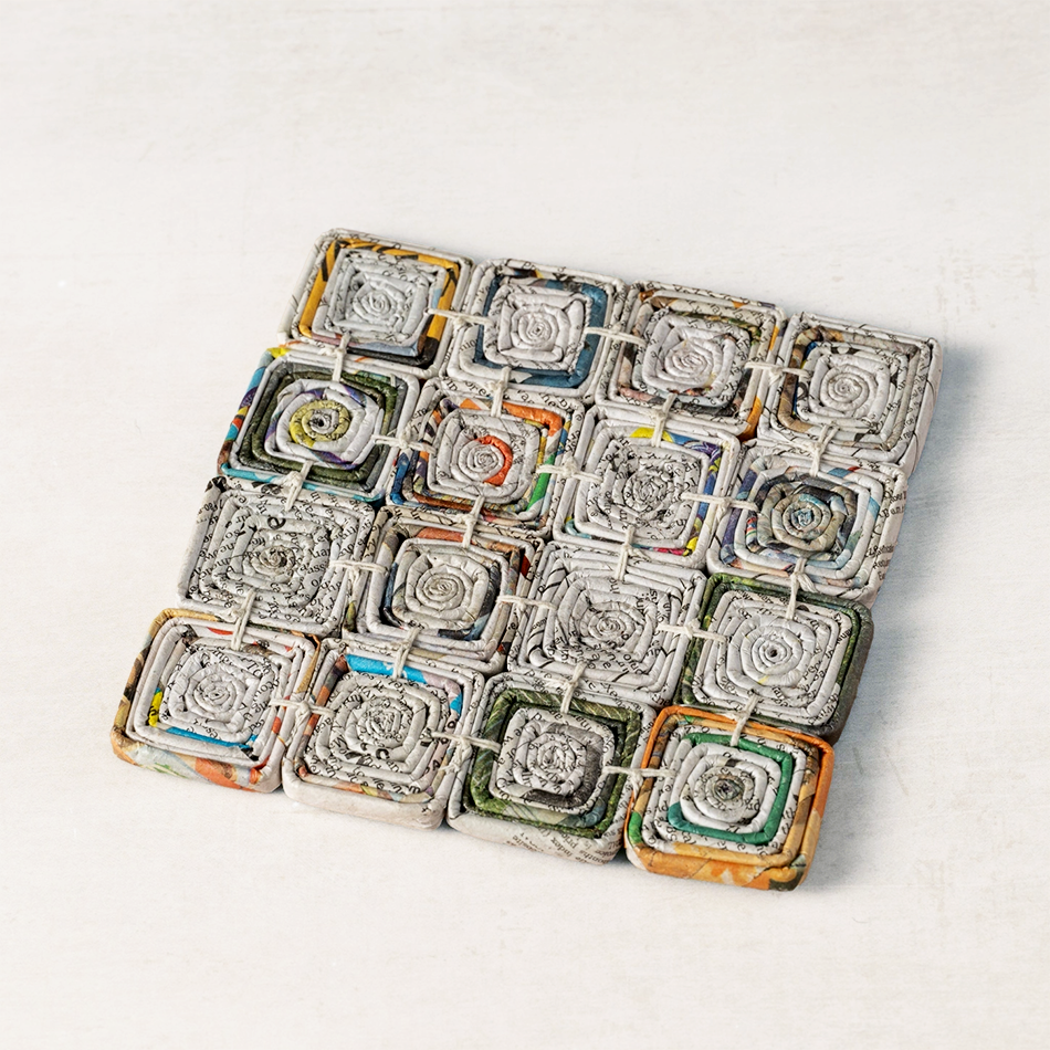 Square trivet made of recycled newspaper