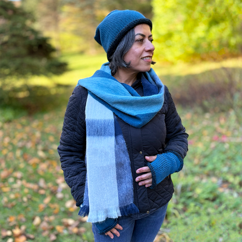 Alpaca scarf with white, gray and blue plaid design on model