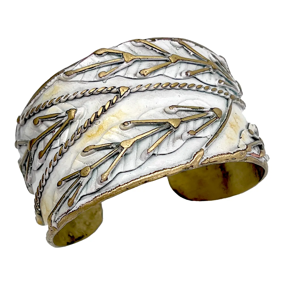 White and brass cuff with patina finish and brass leaf accents.