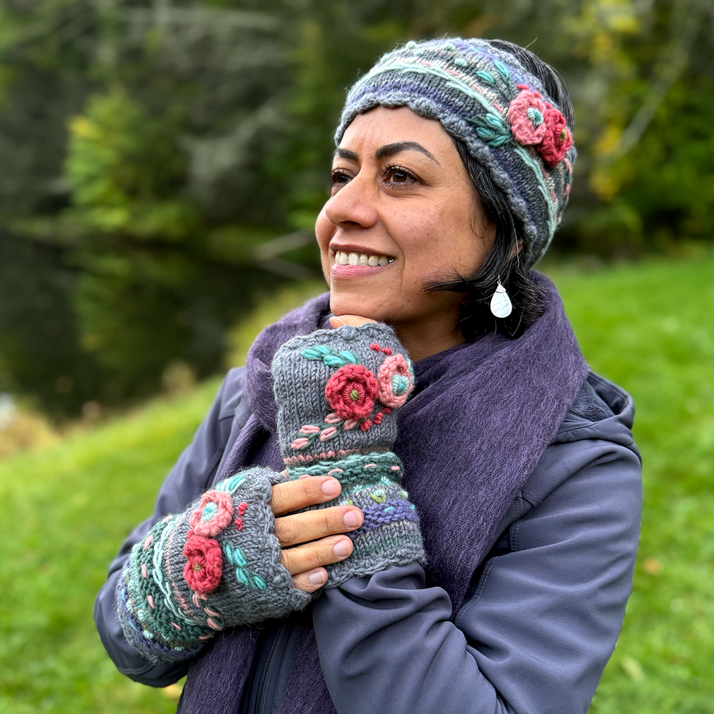 Wool knit fingerless gloves and headband on model gray, lavender with pink and red flowers