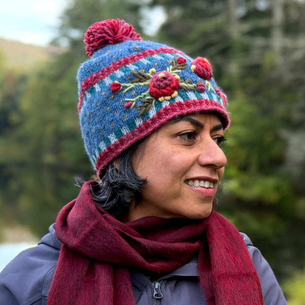 Wool knitted hat blue with red embroidered flowers and red pom pom