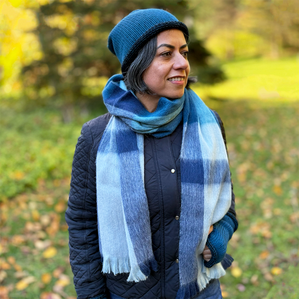 Alpaca scarf with white, gray and blue plaid design on model
