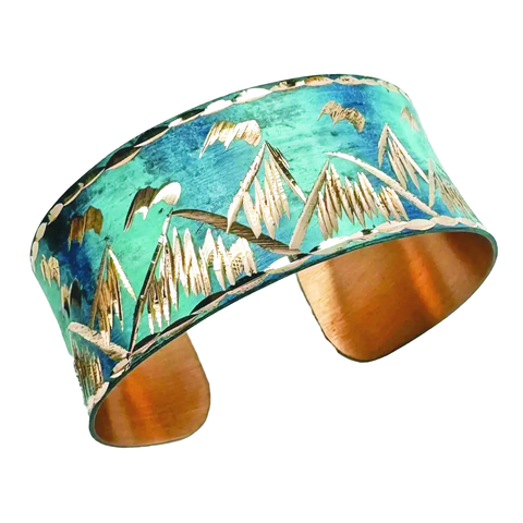 Copper cuff with blue patina and mountain design.