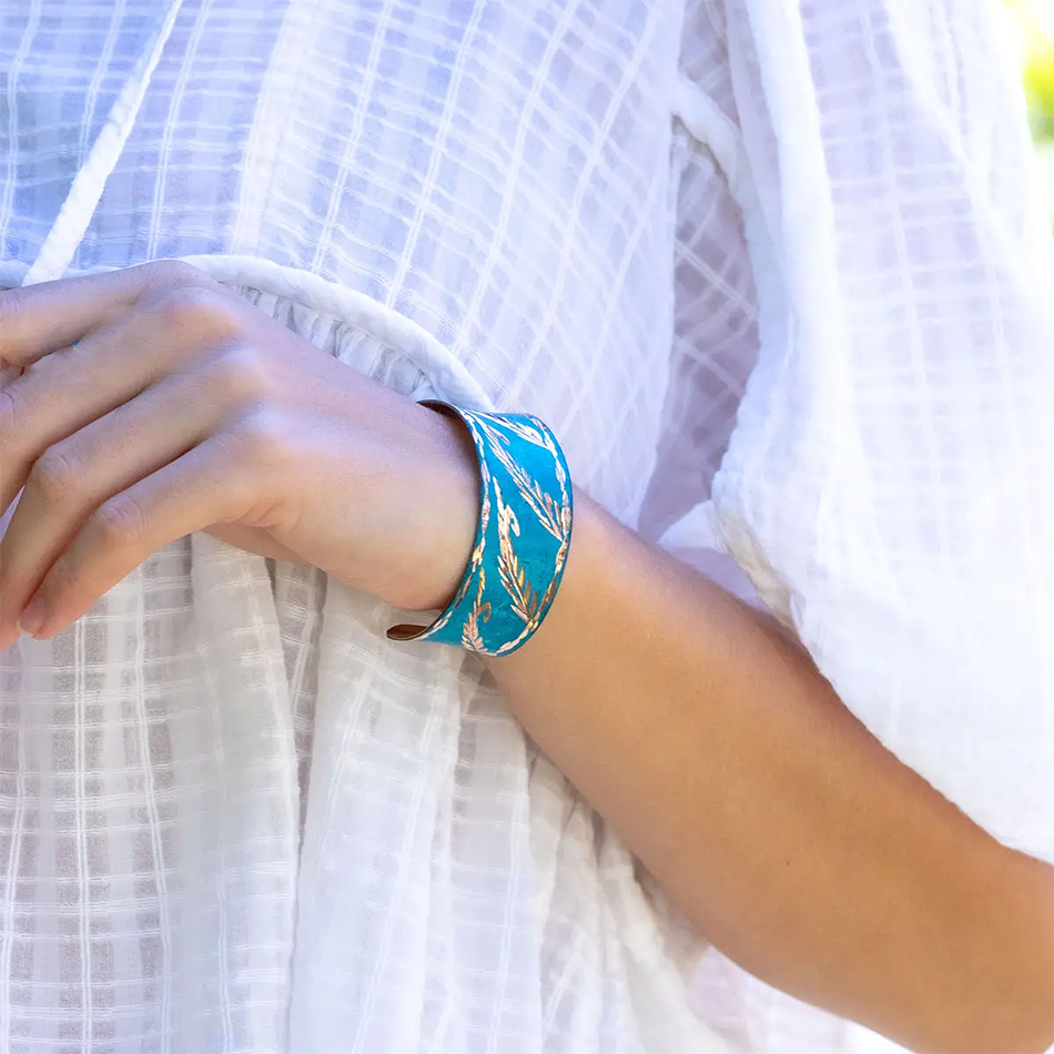 Bright blue copper cuff bracelet with gold leaves