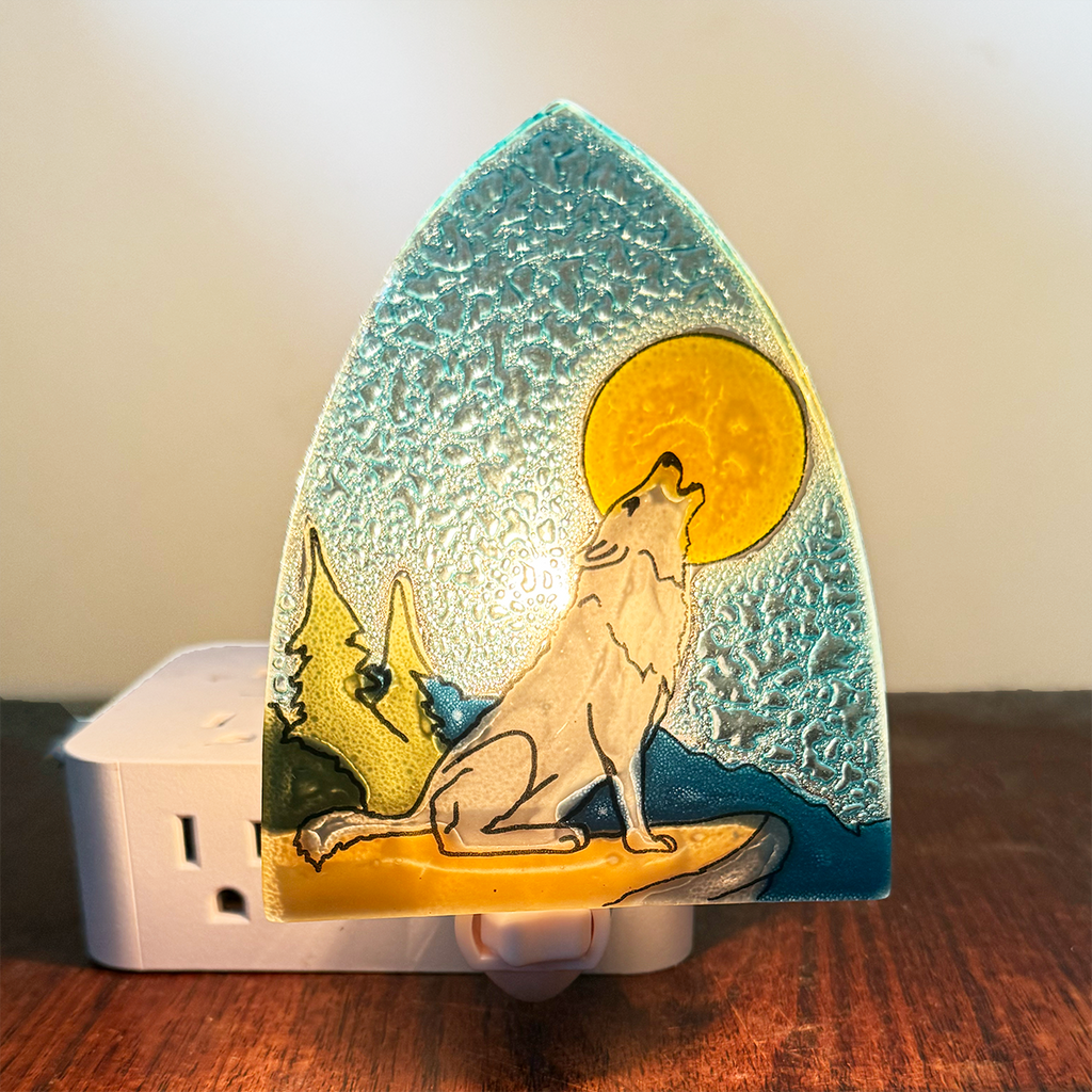 Glass nightlight with wolf howling at a yellow moon