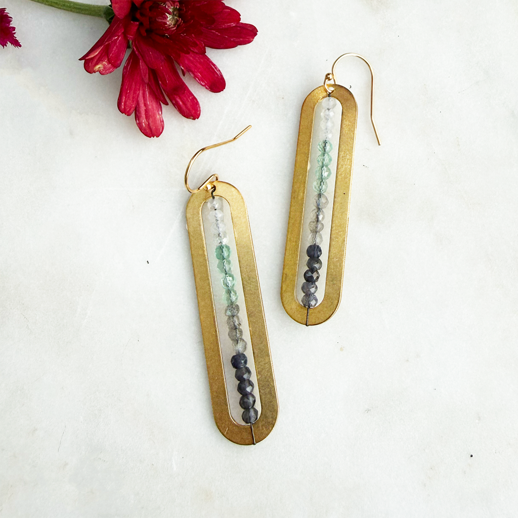 Long brass earrings with tiny stones in the center 