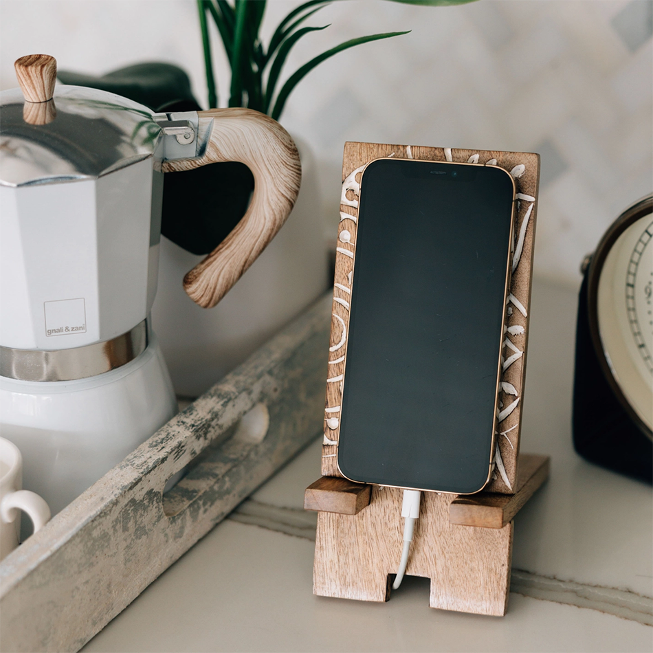 Wood smartphone stand with white painted mandala design.