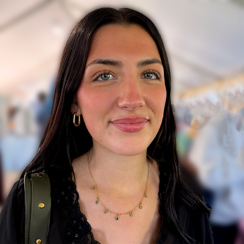 Necklace with delicate brass chain and 7 small green zircon stones hanging as charms.