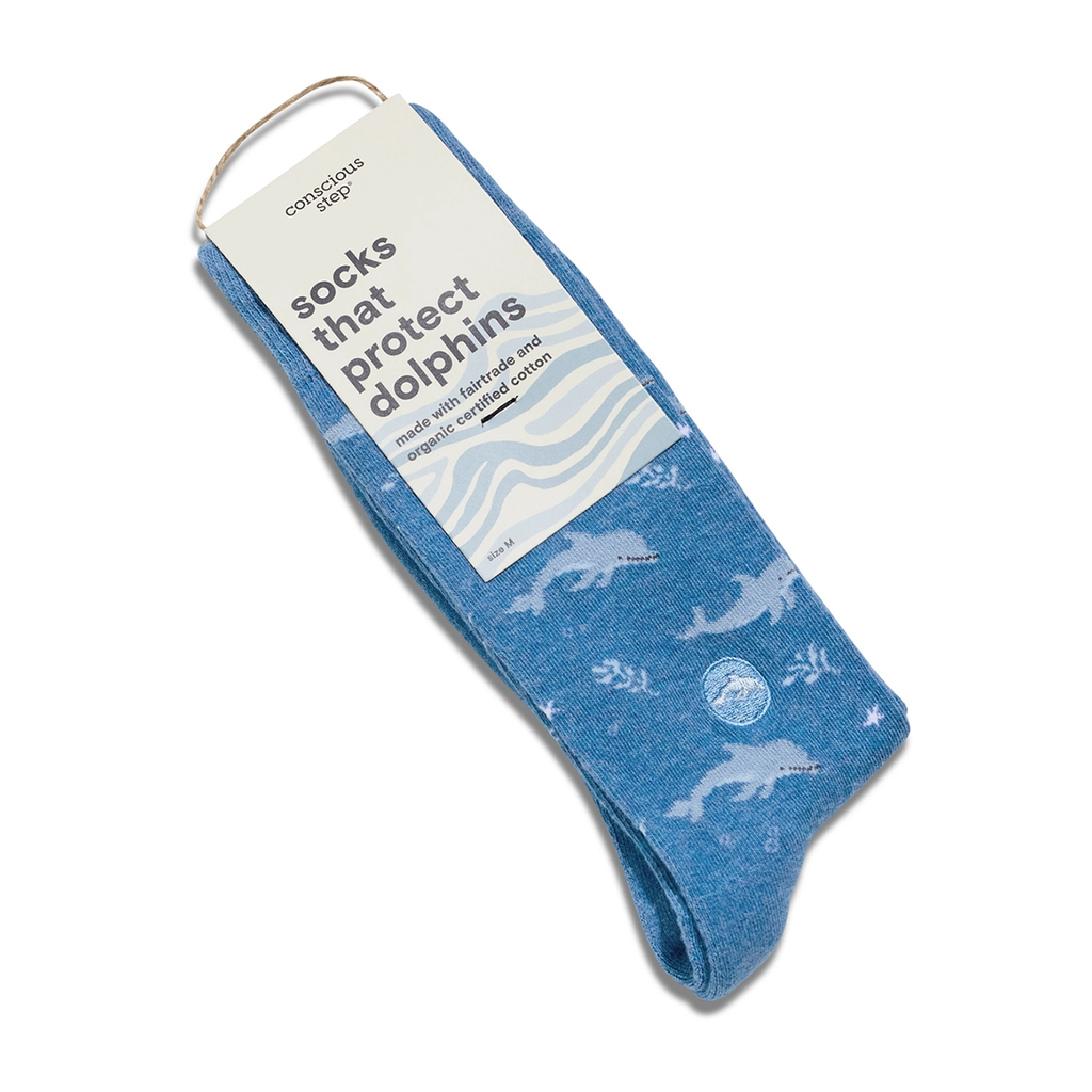 Blue socks with white dolphins all over them tag that says socks that protect dolphins
