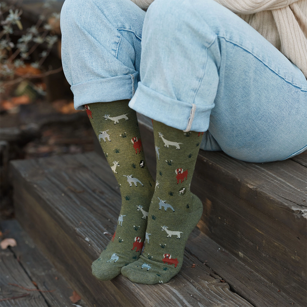 Green socks with red, gray and white goats on model