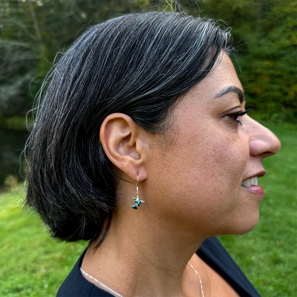 Sterling silver hummingbird earrings with abalone shell on model