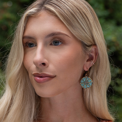 Round dangle earrings with brass sun and green patina finish.