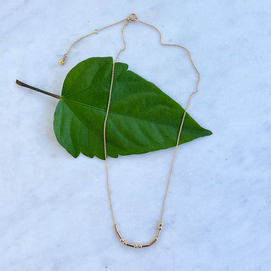 Gold morse code Grace bracelet handmade by survivors of human trafficking in Thailand